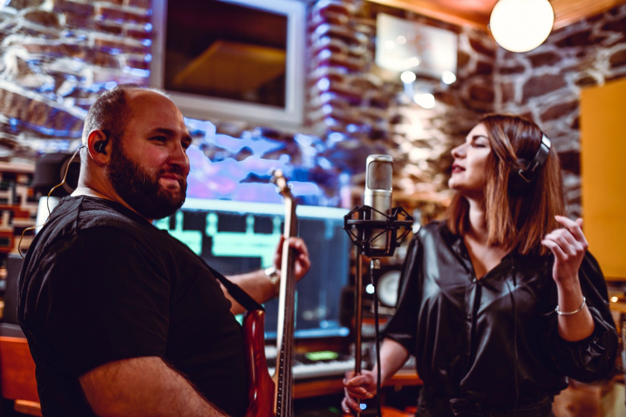People singing and recording together in a music studio