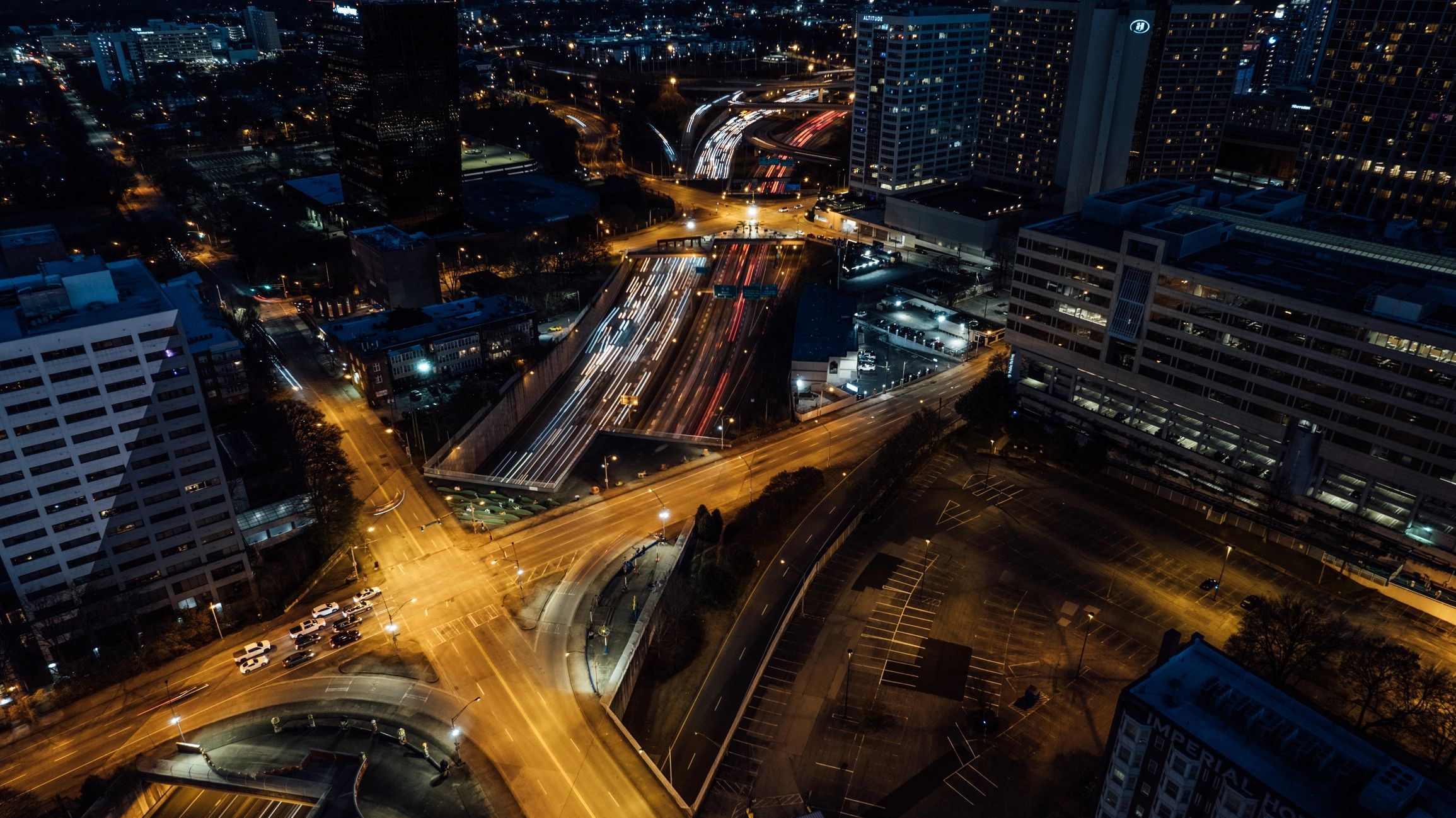 Traffic moving through downtown streets at night