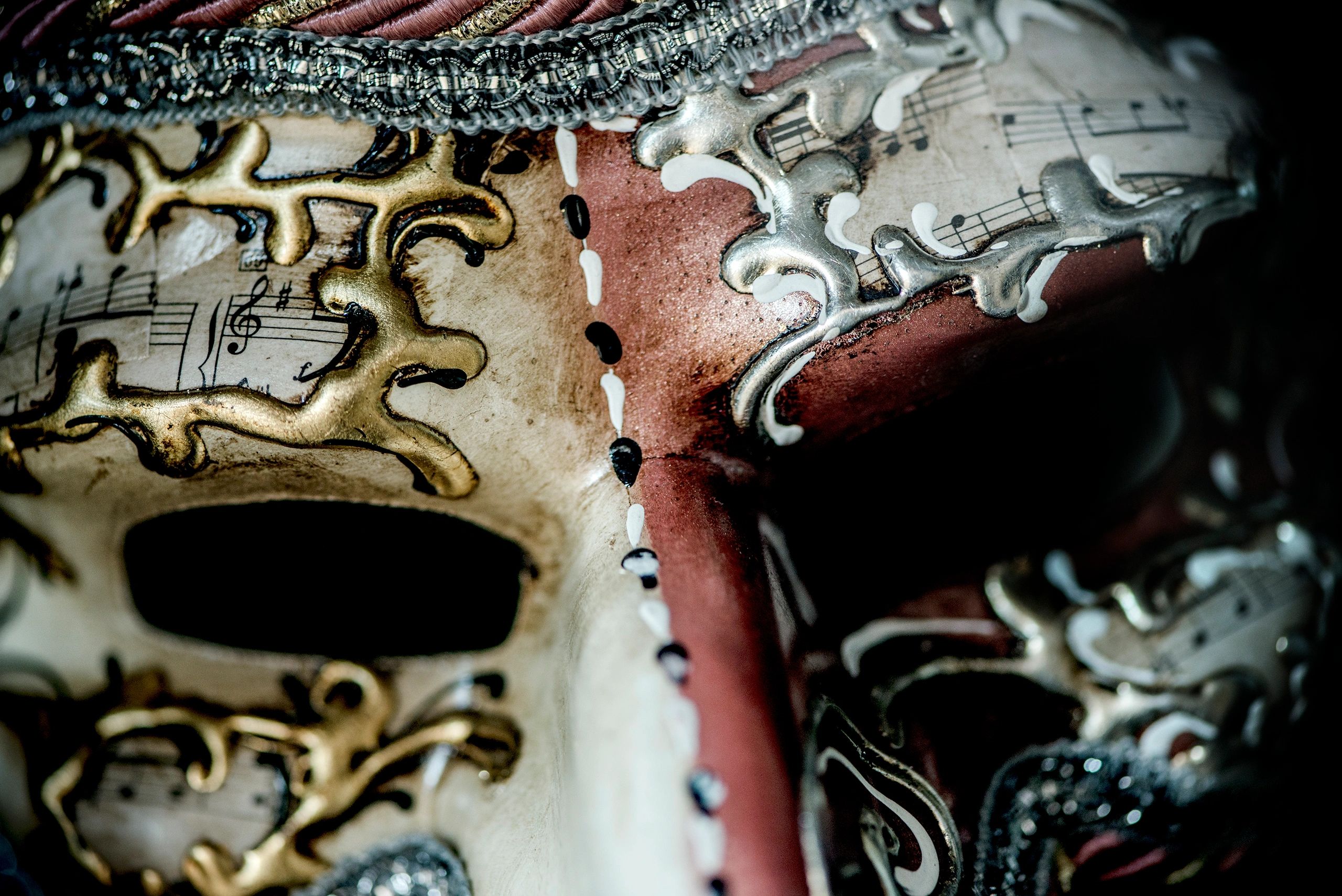 Close-up of a dramatic carnival-style mask in low light