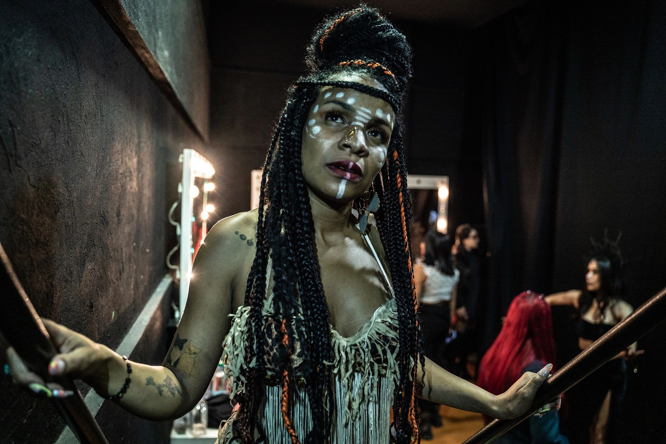 Actor in a dressing room preparing for a performance under warm lights